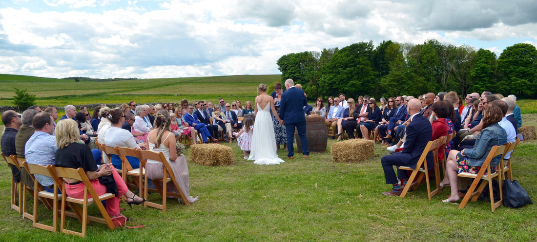 Couple getting married outside with hay bales in Derbyshire